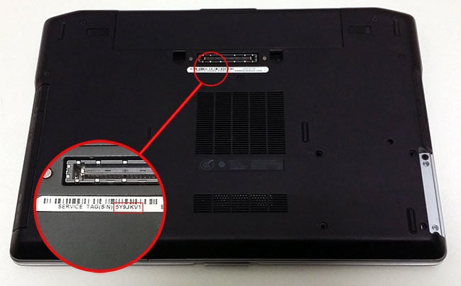 Where is the service tag located on a Dell laptop?